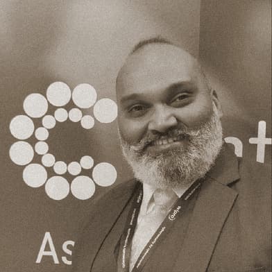Portrait of Ashish Kirtikar, OMPEG Core Group, smiling at a conference.